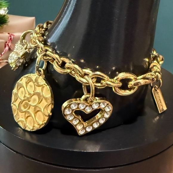 Coach Gold Tone Multi Charm Bracelet. Includes locket Heart, Bird, Star and more - Picture 9 of 17